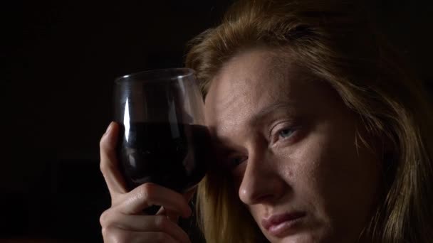 Uma mulher triste e bonita a beber vinho à noite. close-up, 4k, câmera lenta . — Vídeo de Stock