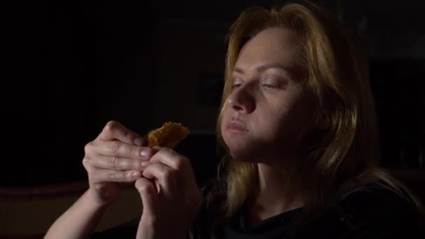 Жінка вночі їсть булочки. концепція харчового розладу. 4k, повільний рух — стокове відео