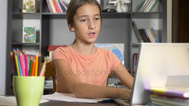 Concept of online learning. the child is enrolled in an online school. girl doing homework with laptop. 4k, slow motion — Stock Video