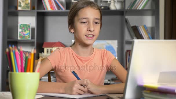 Concept van online leren. het kind wordt ingeschreven in een online school. meisje met laptop huiswerk doen. 4k, slow-motion — Stockvideo
