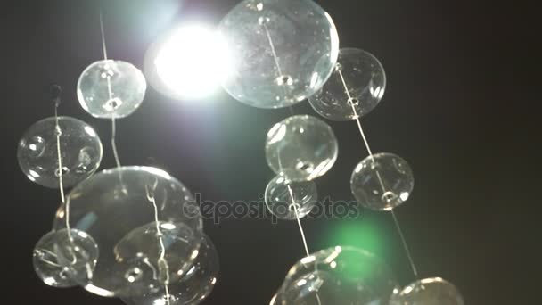 Lamps close-up. Crystal modern chandelier detail background. Hanging lamps in the form of bubbles with a flashing shining reflection. Slow motion. 4k — Stock Video