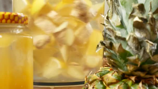 Someone makes a handmade drink from lemons, ginger root and pineapple. 4k — Stock Video