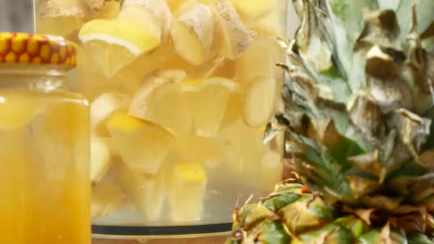 Someone makes a handmade drink from lemons, ginger root and pineapple. 4k — Stock Video