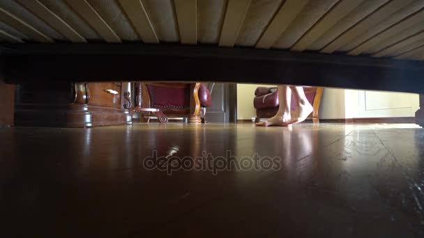 4k. female legs, view from under the bed. the jewelry fell under the bed. — Stock Video