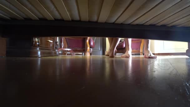 4k, female and male feet view from under the bed. — Stock Video