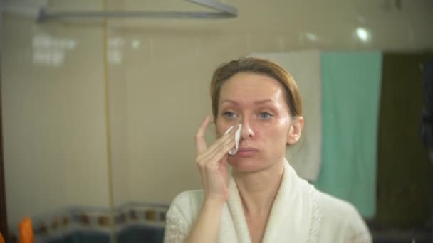 Cara de mujer limpiadora con hisopo de algodón delante del espejo. 4k, cámara lenta. Primer plano. desenfoque de fondo . — Vídeos de Stock