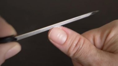Resim tırnaklar manikür. bir kadının tırnaklarını koyu ahşap bir masa üzerinde kapalı testereleri. 4 k, yakın çekim, ağır çekim