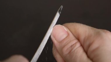 Resim tırnaklar manikür. bir kadının tırnaklarını koyu ahşap bir masa üzerinde kapalı testereleri. 4 k, yakın çekim, ağır çekim