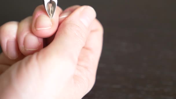 Female hands manicure close up view. Cutting burrs. a woman does herself a manicure with the help of nail clippers. 4k, close-up, slow-motion — Stock Video