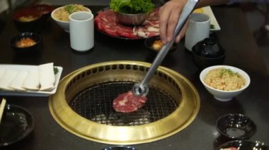 Bulgogi, restoranda Korece Barbekü yiyecek. Barbekü, 4 k, yakın çekim ızgara masada Çin restoranında yemek
