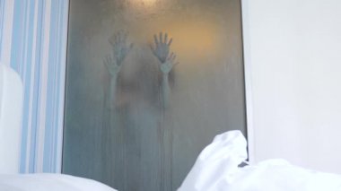 4k, ağır çekim. Tanınmayan çift erkek ve kadın kucaklama ve duşta öp. yatak odası ve banyo arasında şeffaf bir duvar bir puslu camın görüntülemek