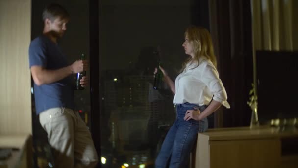 Paar man en vrouw bier drinken 's avonds laat op huis, 4 k, slow-motion — Stockvideo