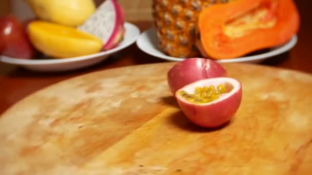 Exotic fruits on the table. 4k. passion fruit, rotates on a cutting board. — Stock Video