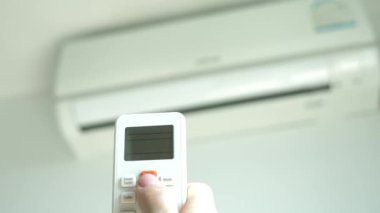 Klima Oda sıcaklığı ayarlamak için elinde bir kablosuz uzaktan kumanda var. 4k, bulanık Klima arka plan üzerinde kontrol panelinin düğmelere basarak el