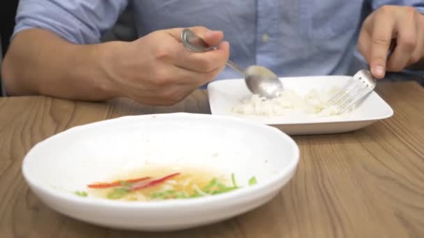 Cozinha tailandesa - arroz, omelete, verduras com o porco. Um homem come comida tailandesa num restaurante. 4k, câmera lenta — Vídeo de Stock