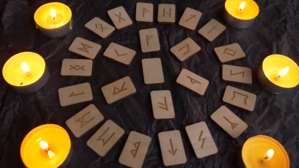 Fából készült rune kerék. rovásírásos elrendezés és gyertyák, 4k, lassú mozgású felvétel — Stock videók