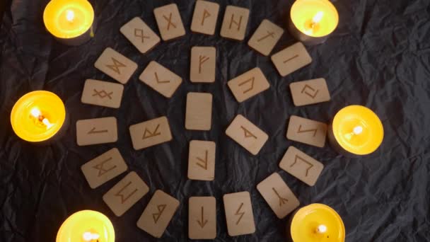 Wooden rune wheel. runic layout and candles, 4k, slow-motion shooting — Stock Video