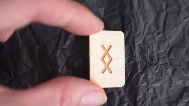 Inguz rune. close-up, hand puts the rune on the surface for divination. 4k, slow-motion — Stock Video