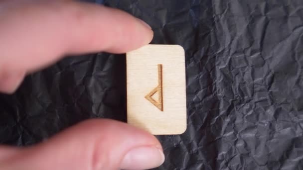 Wunjo umgekehrte Rune. Nahaufnahme, Hand legt die Rune auf die Oberfläche für die Wahrsagerei. 4k, Zeitlupe — Stockvideo