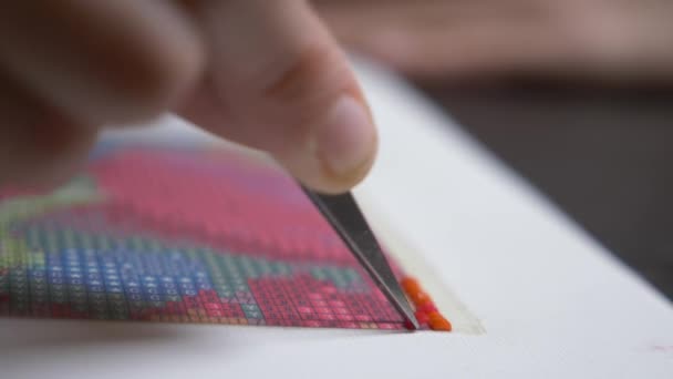 The mosaic process, the girls hand holding tweezers, making a mosaic. 4k, close-up — Stock Video