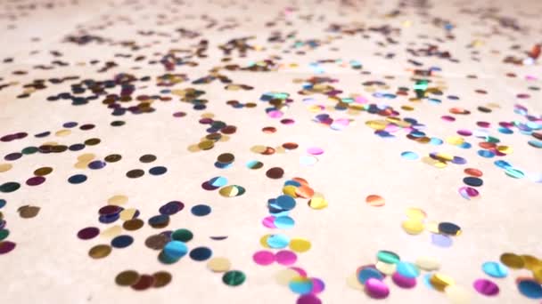 Slow motion. 4k. round multicolored confetti lie on the tiled floor. dolly shooting — Stock Video