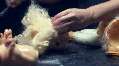 Erkek elleri eski bir oyuncağın kafasını kesmiş. Cadılar Bayramı konsepti, şiddet, manyak