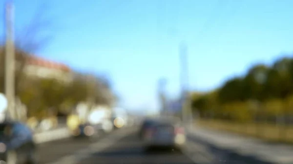 blurred background. Cars drive along the highway on a city bypass on a clear summer day. copy space. blue sky