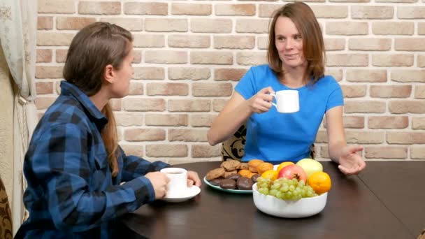 Lesbian family drinking tea at home . against a brick wall — Stockvideo