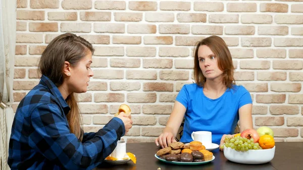 Lesbian family drinking tea at home . against a brick wall — Stock Photo, Image