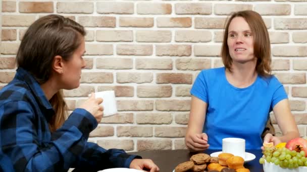 Lesbian family drinking tea at home . against a brick wall — Stockvideo