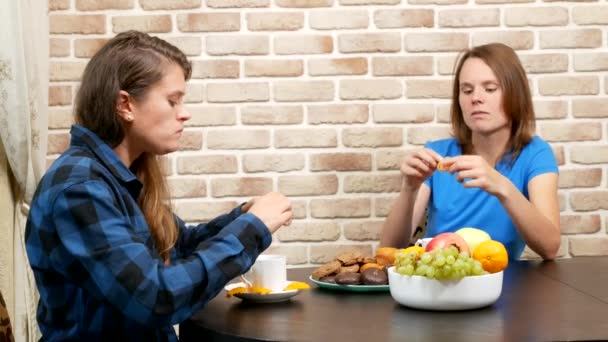 Lesbian family drinking tea at home . against a brick wall — Stockvideo