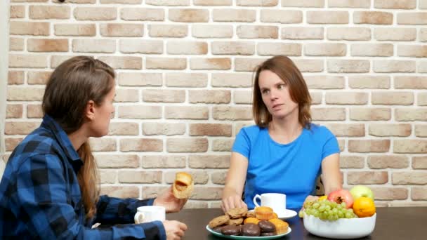 Lesbian family drinking tea at home . against a brick wall — Stockvideo