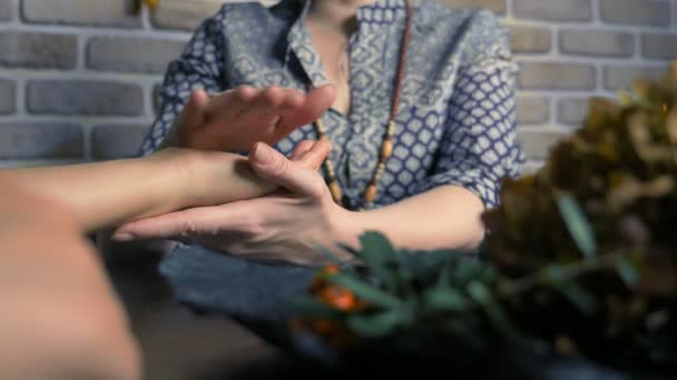 Handpalmerie. de waarzegster voorspelt de toekomst van een vrouw door haar hand — Stockvideo