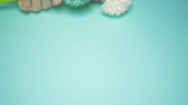 wooden hand holding artificial flowers. blue background