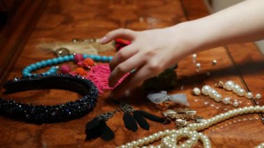 a variety of jewelry from natural stones and feathers are on the table.