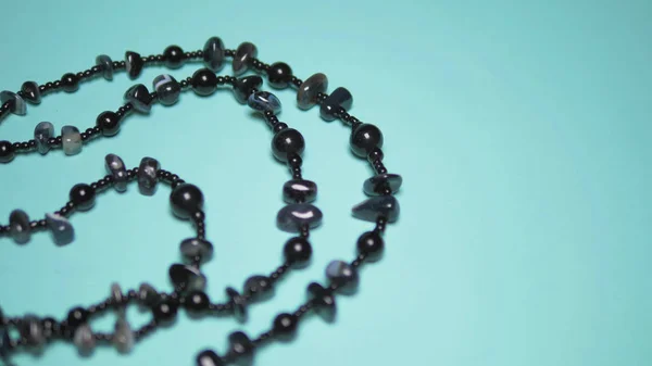 Belles perles d'agate noires sur un fond bleu. design art mode — Photo