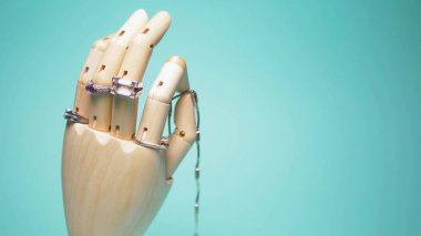 silver jewelry hanging on wooden layout hands. stylish design. blue background.