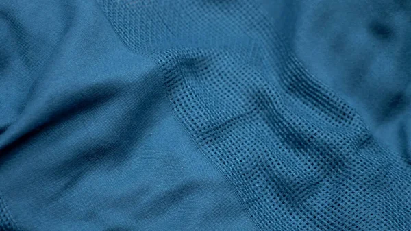 背景のテクスチャ生地。青い綿の布の折り目です。コピースペース — ストック写真