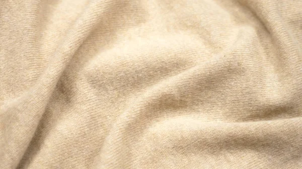 Struttura del tessuto di sfondo. pieghe di tessuto di cashmere beige. primo piano — Foto Stock