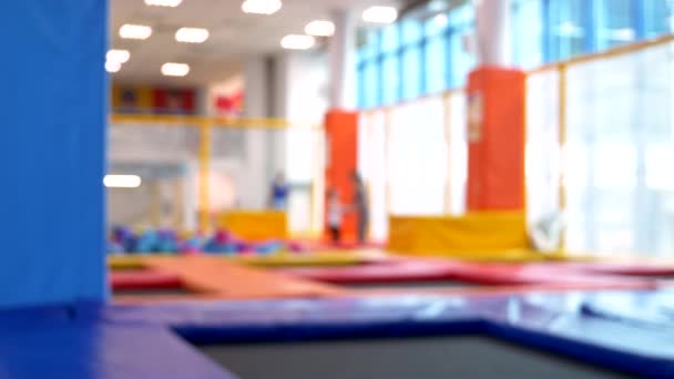 Blurred background. children jumping on trampolines at trampoline center — Stock Video