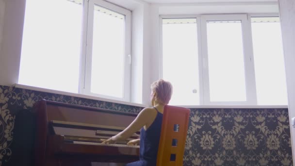 Elegant fragile woman plays piano at home in the living room — Stock Video