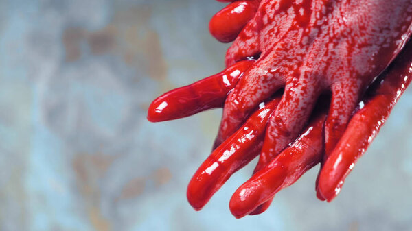 bloody hands, blood dripping from his hands. copy space