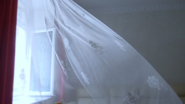 A transparent curtain on the window, gently moved by the wind in the room — Stock Video