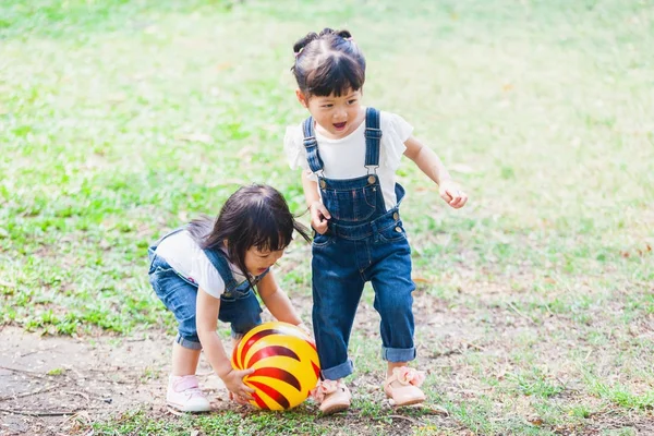 Lindos niños de 2 a 3 años jugando a la pelota en el jardín —  Fotos de Stock