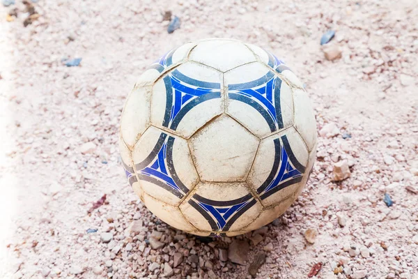 Old soccer ball on the ground