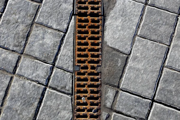 Gutter drainage, covered with steel lattice — Stock Photo, Image