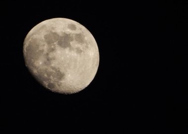 Photo of a Three Quarter moon at night clipart