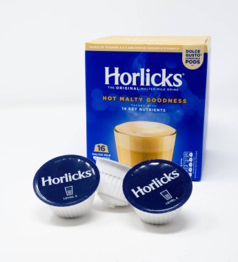 Reading, United Kingdom - December 29 2019:  A box and three pods of Horlicks malted milk drink for a Dolce Gusto coffee machine clipart