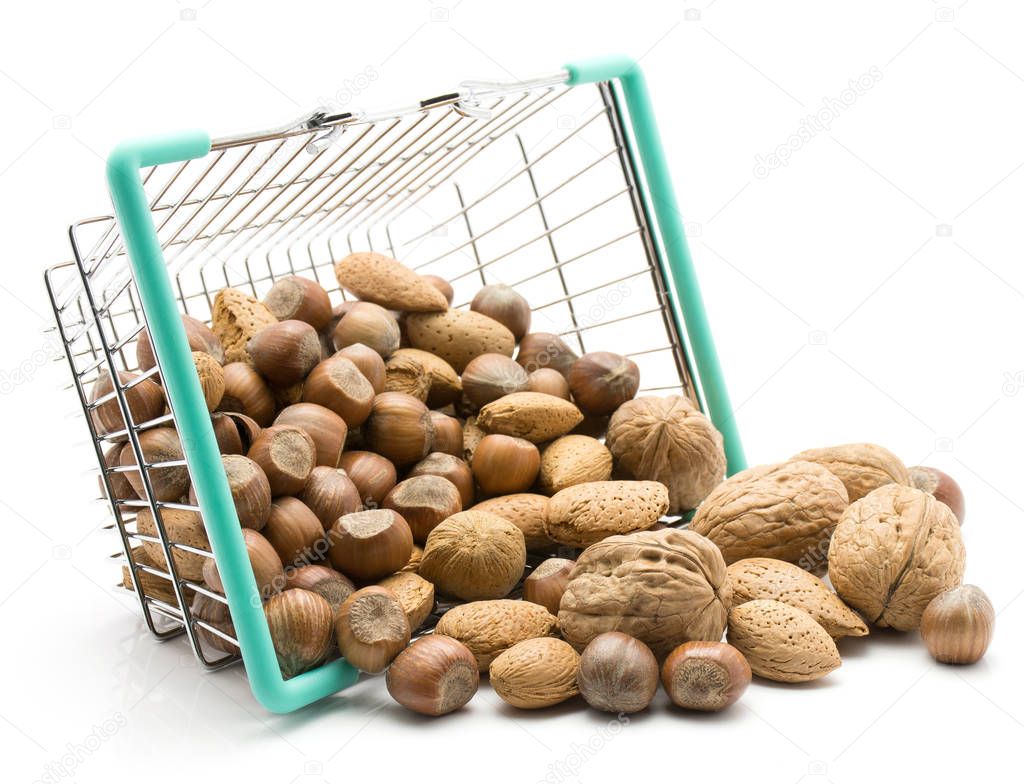 Nuts mix (walnut, hazelnut and almond) out a shopping basket isolated on white backgroun