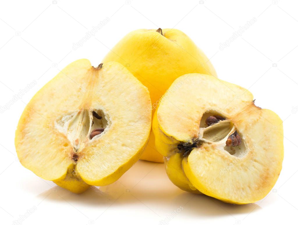 Two yellow quinces one cut in half isolated on white background raw ripe two halves